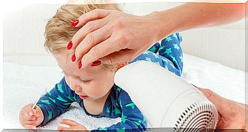 Use a hair dryer to gently remove the water from your ears.